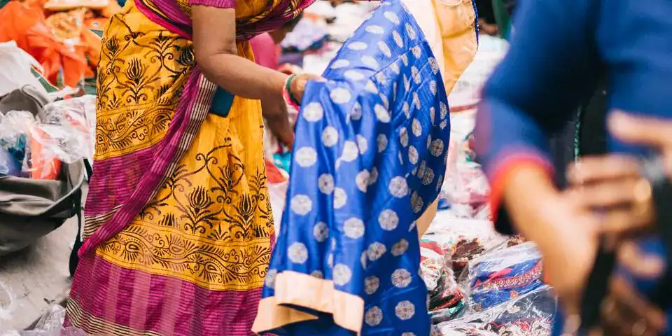 Indian woman folding saree Indian woman folding saree