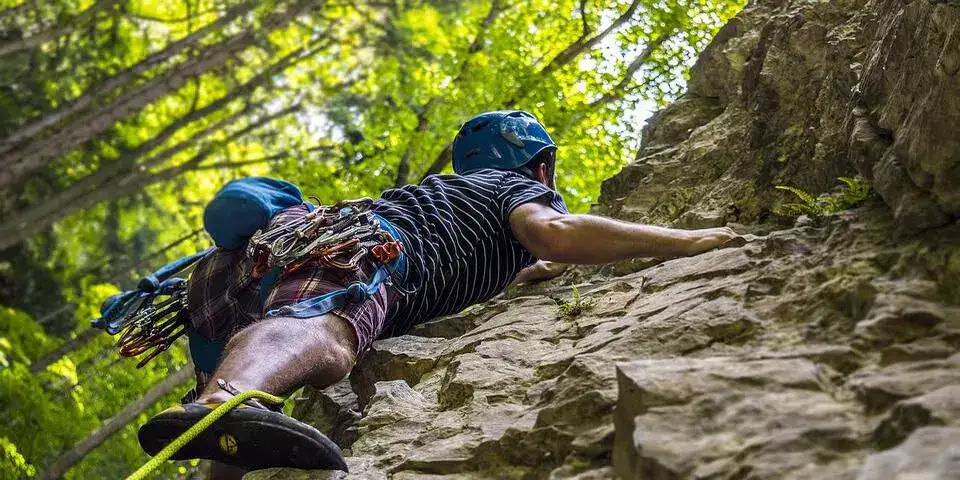 a man doing rockclimbing a man doing rockclimbing