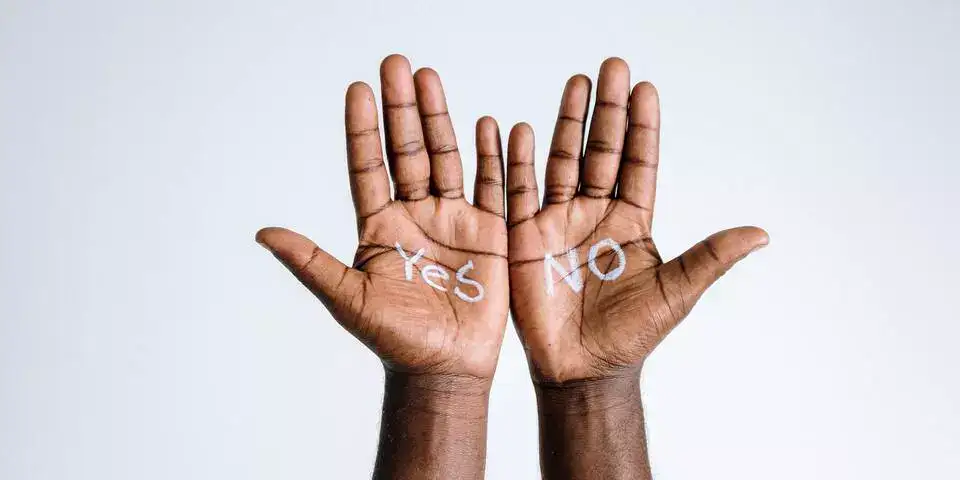 yes and no written on hands yes and no written on hands